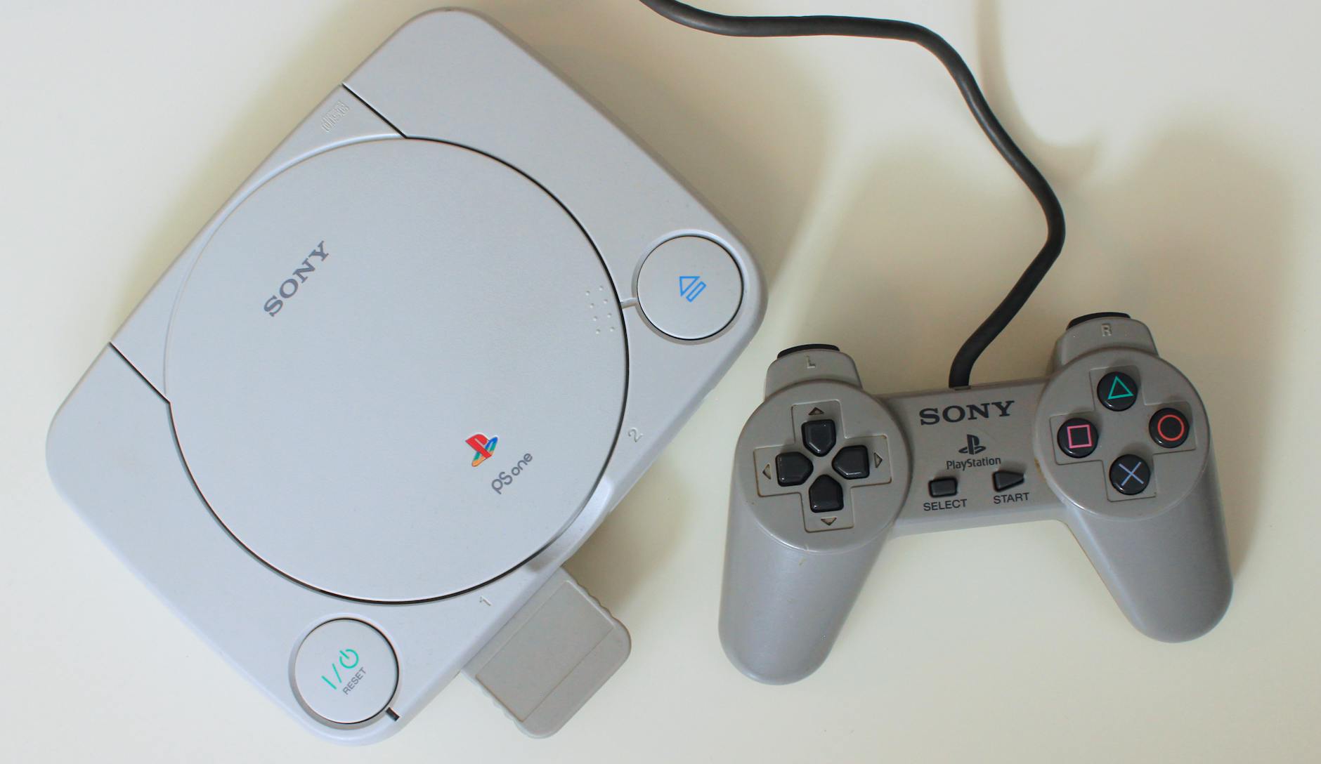 close up shot of a game console beside a game controller